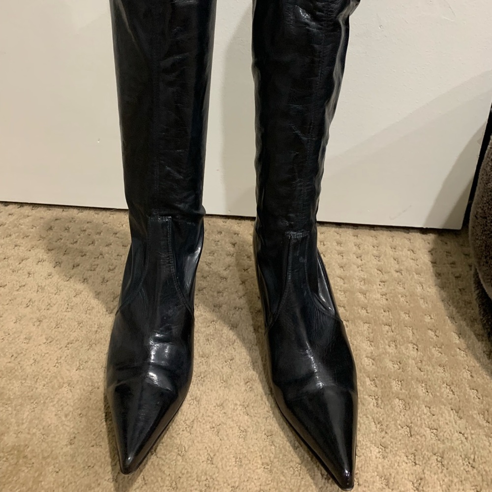 Knee high boots with steel heel.